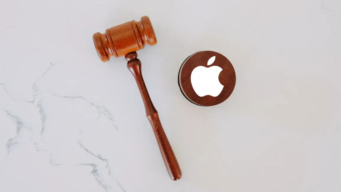 Wooden gavel and an Apple logo image on a marble surface