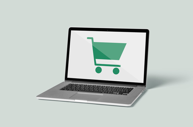 laptop with a shopping cart on the screen