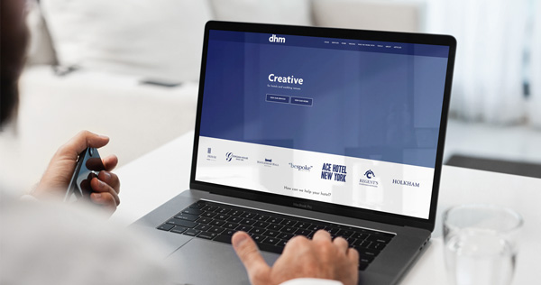 Innovation Visual client DHM's website on laptop