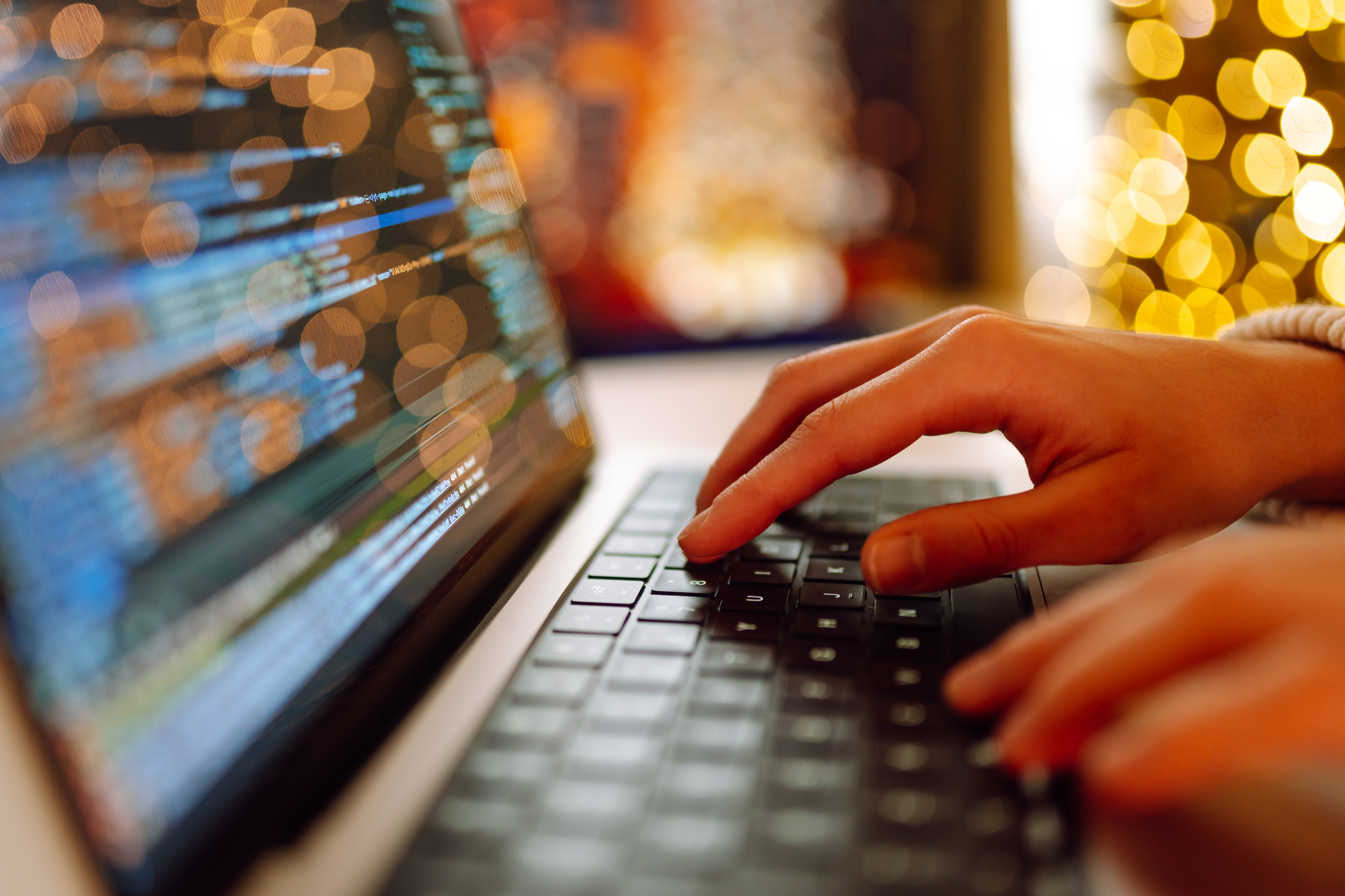 An individual typing the perfect prompt for AI on a laptop