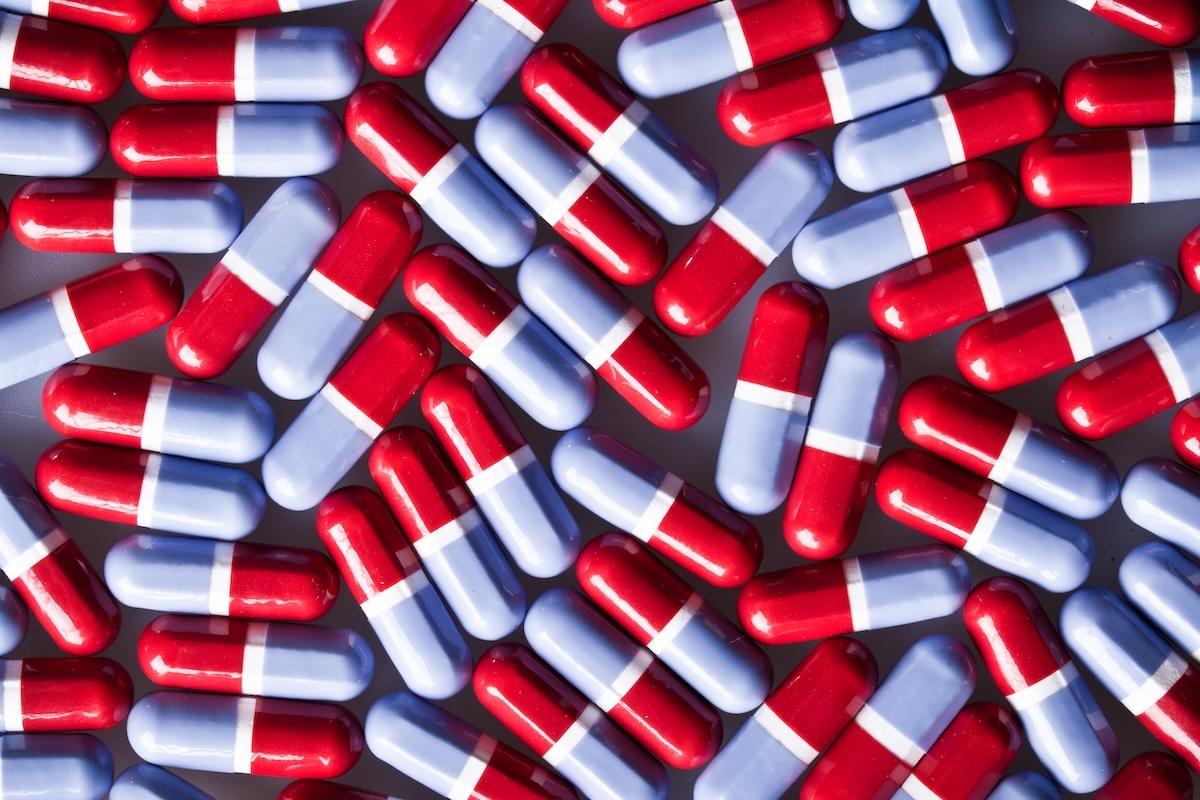 An image of pills highlighting to pick the painkiller, not the vitamin