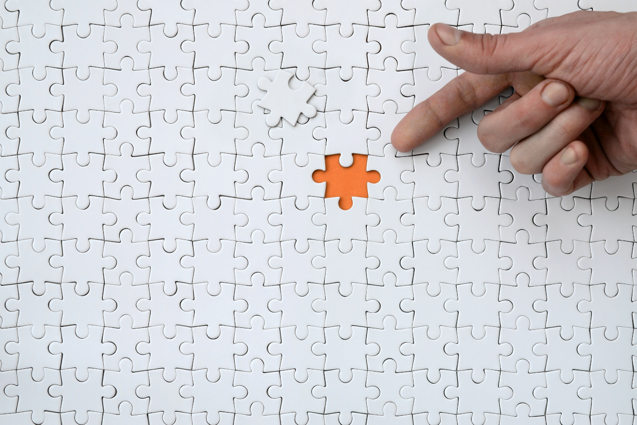 A Jigsaw puzzle with the final piece missing.